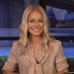 Kelly’s beige tie neck blouse on Live with Kelly and Mark