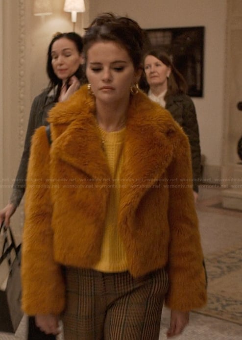 Mabel's orange fur jacket and plaid pants on Only Murders in the Building