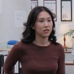 Nicole’s brown top and navy belted pants on The Paper