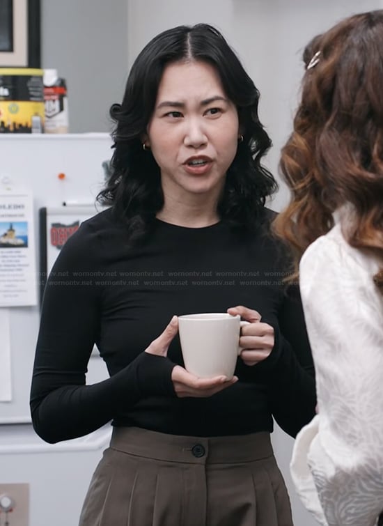 Nicole’s black long sleeve top on The Paper