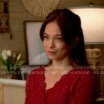 Cassandra’s red scalloped trim sweater on Murder in a Small Town