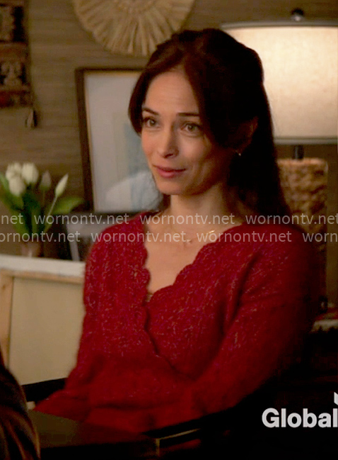 Cassandra's red scalloped trim sweater on Murder in a Small Town