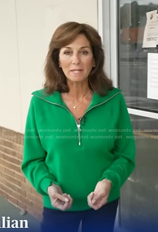 Janet Shamlian’s green half zip sweatshirt on CBS Evening News