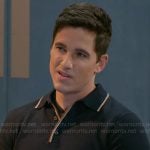 Smitty’s navy polo sweater with striped trim on Beyond the Gates