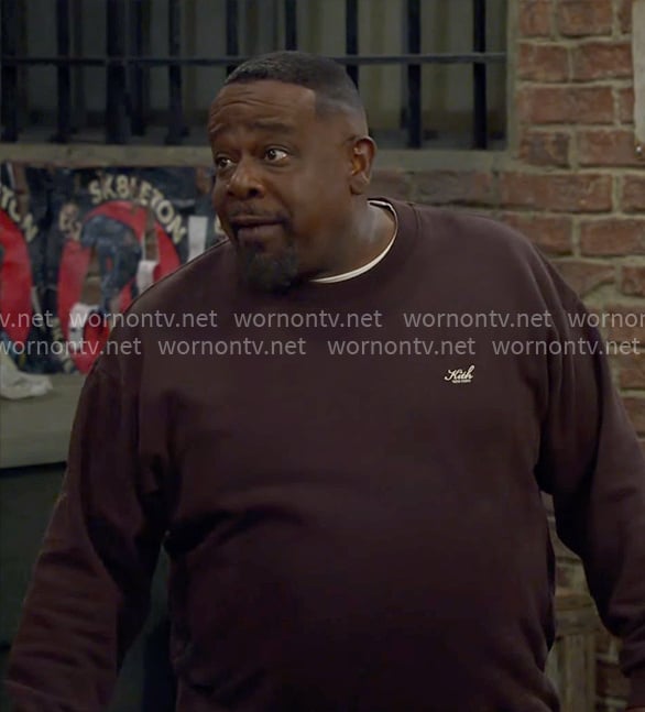 Calvin’s brown Kith sweater on The Neighborhood