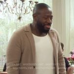 Malcolm’s beige knit jacket on The Neighborhood