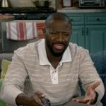 Malcolm’s light beige striped polo shirt on The Neighborhood