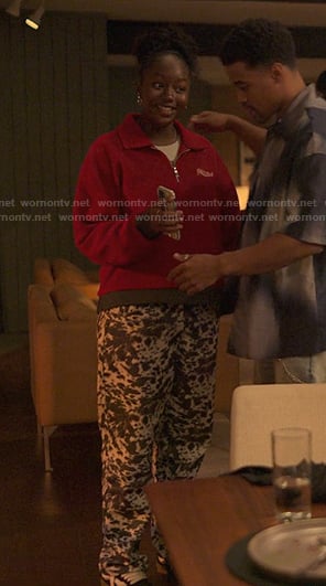 Naima’s red half zip sweatshirt and print pants on Reasonable Doubt