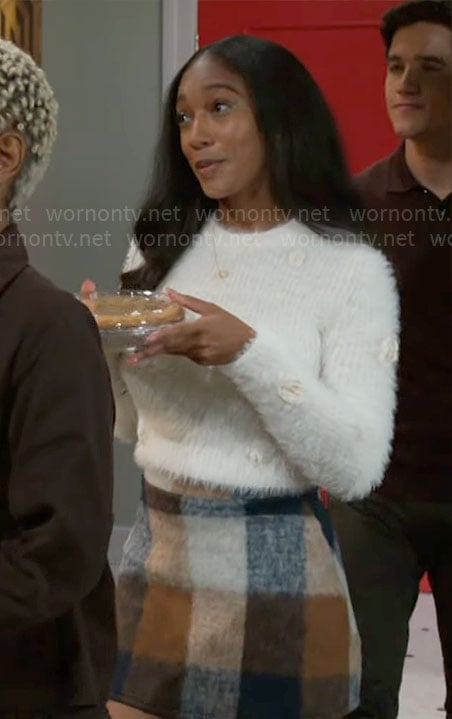 Samantha’s white fluffy sweater and checked skirt on Beyond the Gates