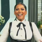 Tamron’s white tuxedo blouse and vest on Tamron Hall Show