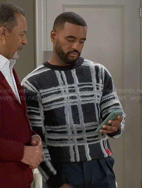 Andre’s checked print sweater on Beyond the Gates