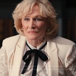 Dina’s white ruffle blouse with velvet tie on Alls Fair