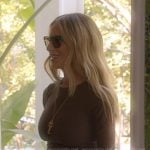 Dorit’s brown knit dress and white pumps on The Real Housewives of Beverly Hills