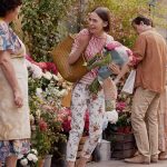 Emily’s floral print pants and yellow flats on Emily in Paris