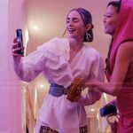 Emily’s printed pants and clutch bag on Emily in Paris