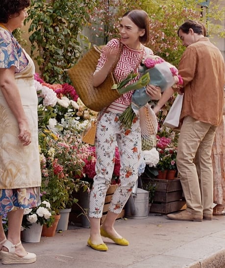 Emily's floral print pants and yellow flats on Emily in Paris