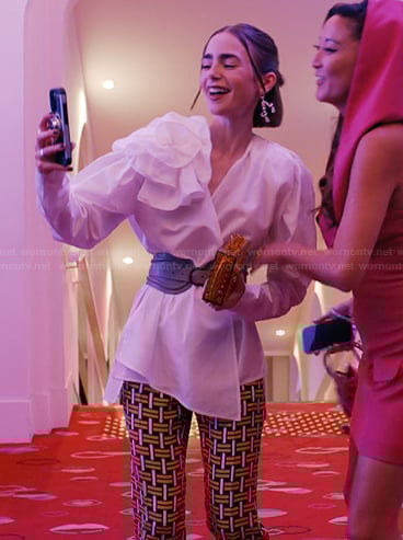 Emily's printed pants and clutch bag on Emily in Paris