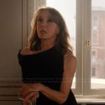 Sylvie’s black asymmetric dress on Emily in Paris