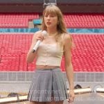 Taylor Swift’s cream button front top and grey pleated skirt on The End of an Era