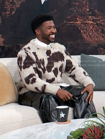 Trell Thomas’s white and brown animal print sweater on Access Hollywood