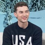Adam Ribbon’s navy USA Olympics sweater on Access Hollywood