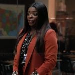 Ava's printed blouse and orange suit on Abbott Elementary