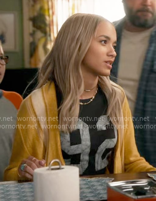 Ava's 92 tee and yellow cardigan on High Potential