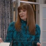 Pamela’s blue abstract print turtleneck on Beyond the Gates