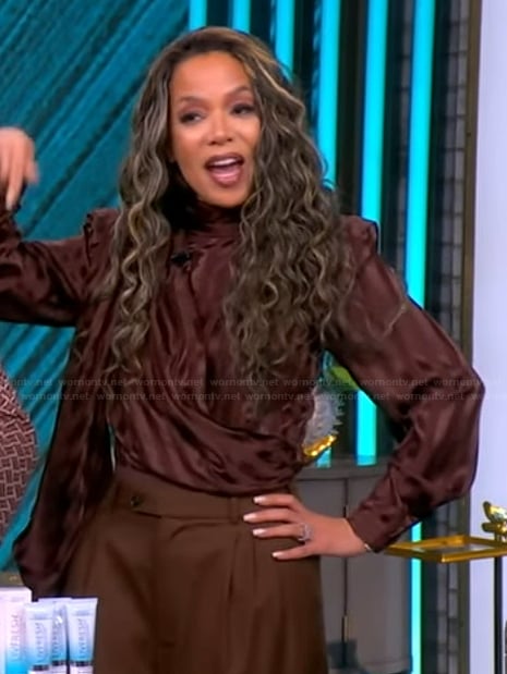 Sunny’s brown satin tie neck top on The View