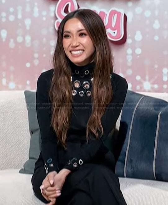 Brenda’s black grommet embellished sweater on Access Hollywood