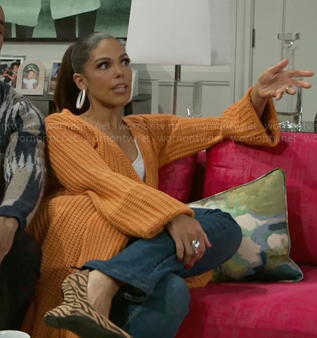 Dani’s long orange cardigan on Beyond the Gates