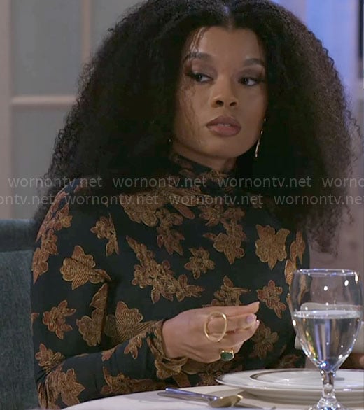 Eva's black floral print top on Beyond the Gates