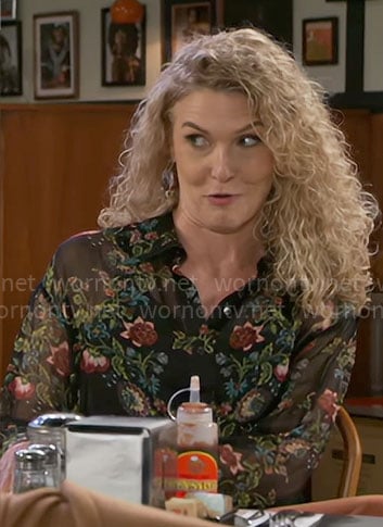 Jan’s black floral top on Beyond the Gates