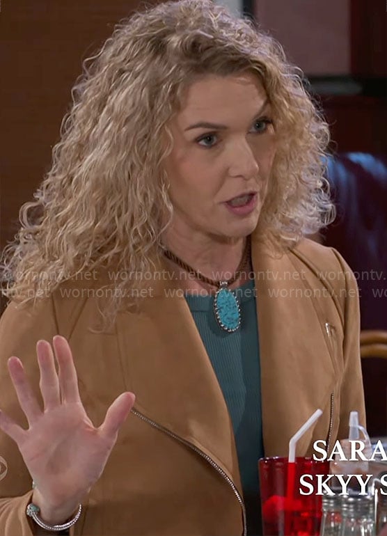 Jan’s tan jacket and turquoise necklace on Beyond the Gates