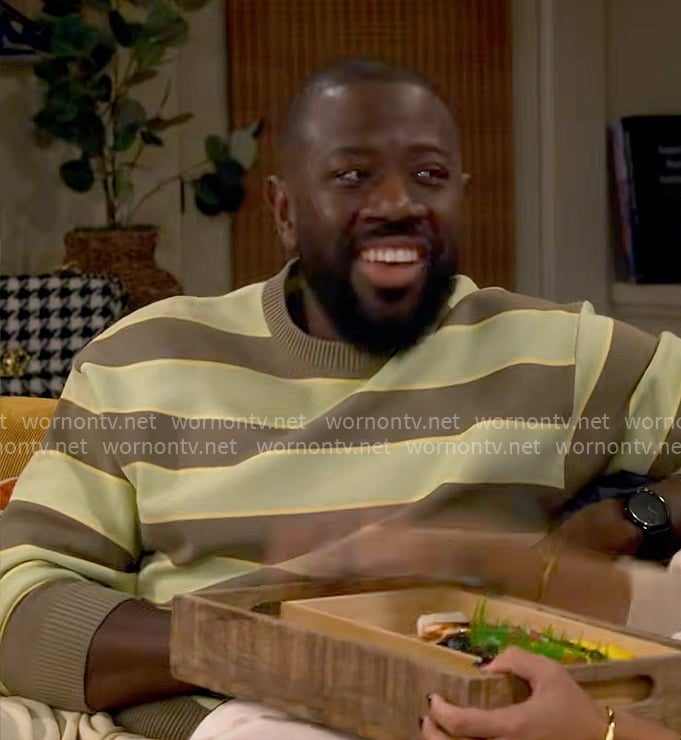 Malcolm’s green and brown striped sweater on The Neighborhood