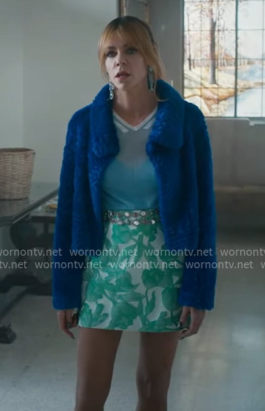 Morgan's blue fur jacket, green printed mini skirt, and fish earrings on High Potential