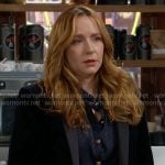Mariah’s navy blouse with gold buttons on The Young and the Restless
