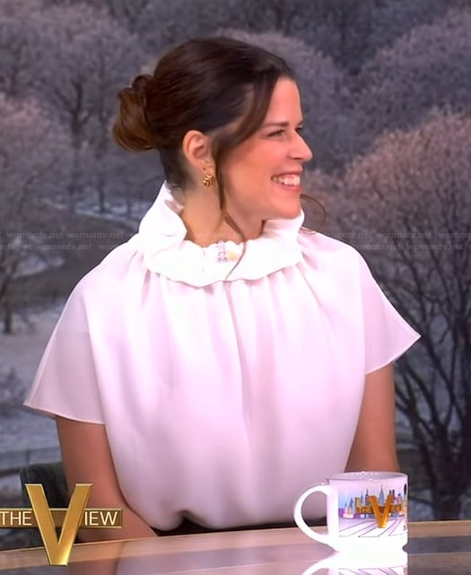 Neve Campbell's white ruffle neck top on The View