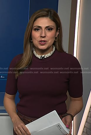 Rana Novini’s burgundy ruffle neck short sleeve sweater on NBC News Daily