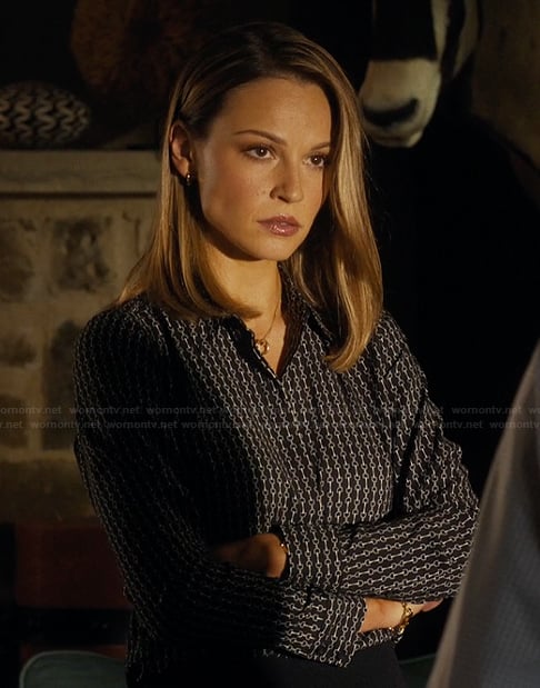 Rebecca's black chain link print blouse on Landman