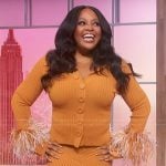 Sherri’s orange feather trim cardigan and skirt on Sherri