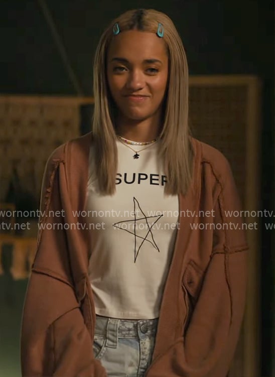 Ava’s Super Star tee and orange cardigan on High Potential