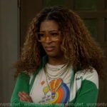 Courtney’s balloon graphic tee and green jacket on The Neighborhood