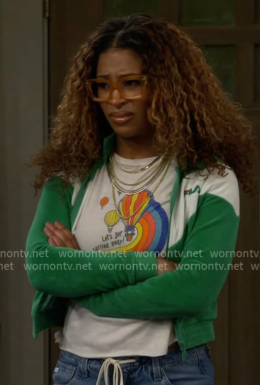 Courtney’s balloon graphic tee and green jacket on The Neighborhood