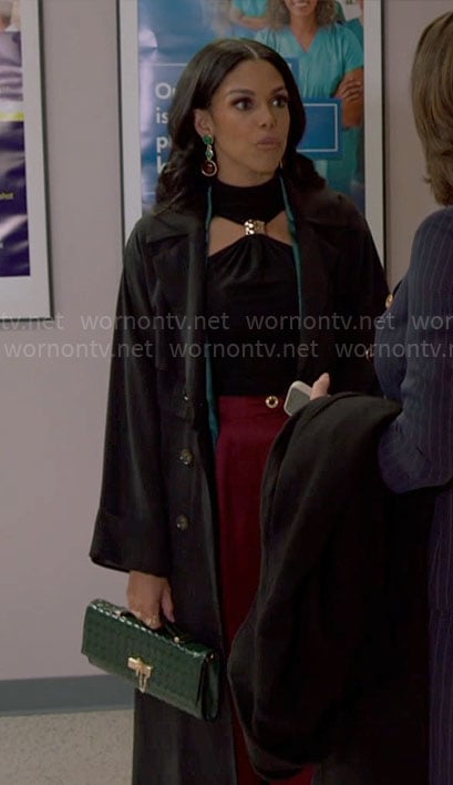 Dani's black halter top with metal detail and green satin jacket on Beyond the Gates