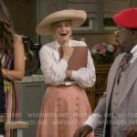 Gemma’s white tie-neck blouse and coral skirt on The Neighborhood