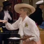 Gemma's white tie-neck blouse and coral skirt on The Neighborhood