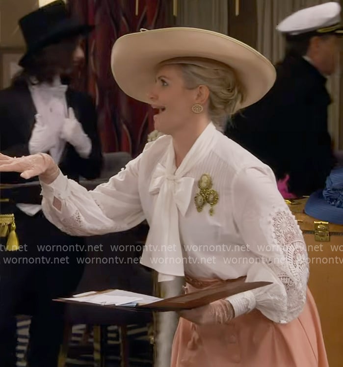 Gemma’s white tie-neck blouse and coral skirt on The Neighborhood