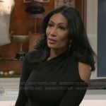 Leslie’s black asymmetric cutout top and leather buckle skirt on Beyond the Gates