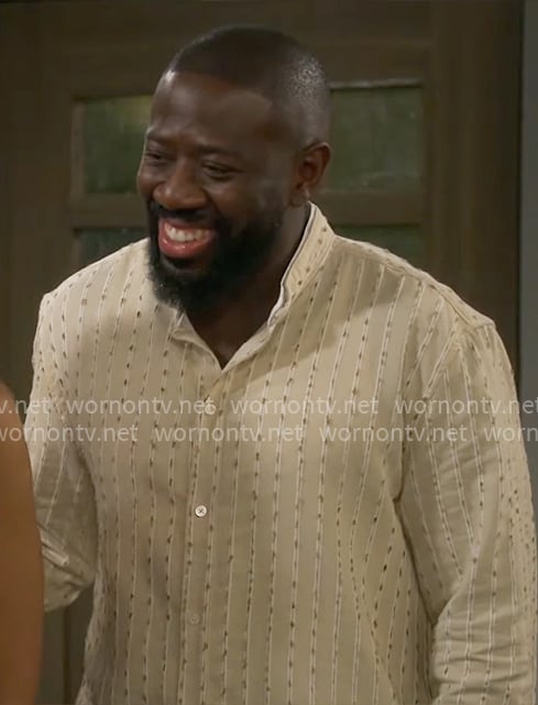 Malcolm’s beige striped shirt on The Neighborhood